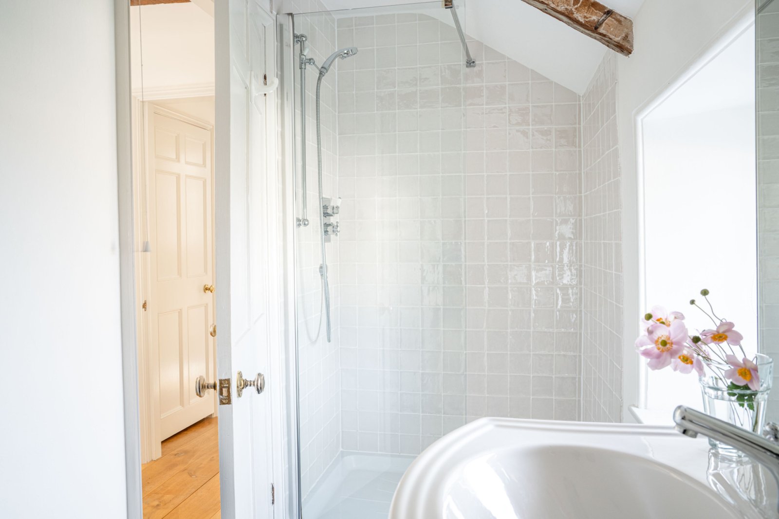 The house has  four bath/shower bathrooms, and three bedrooms, with at least one bath or shower room on each of the three floors.  All are very similar.